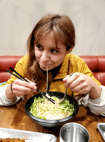 Aida being cute slurping noodles at Northern Cafe